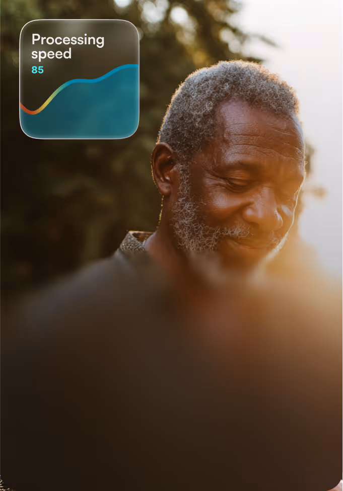 Smiling older man with gray hair and beard outdoors during sunset, with a graphic showing processing speed of 85.