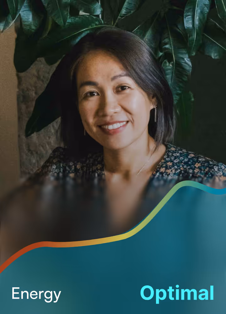 Smiling woman with short dark hair in front of large green leaves with colorful wave overlay and text reading 'Energy Optimal'.
